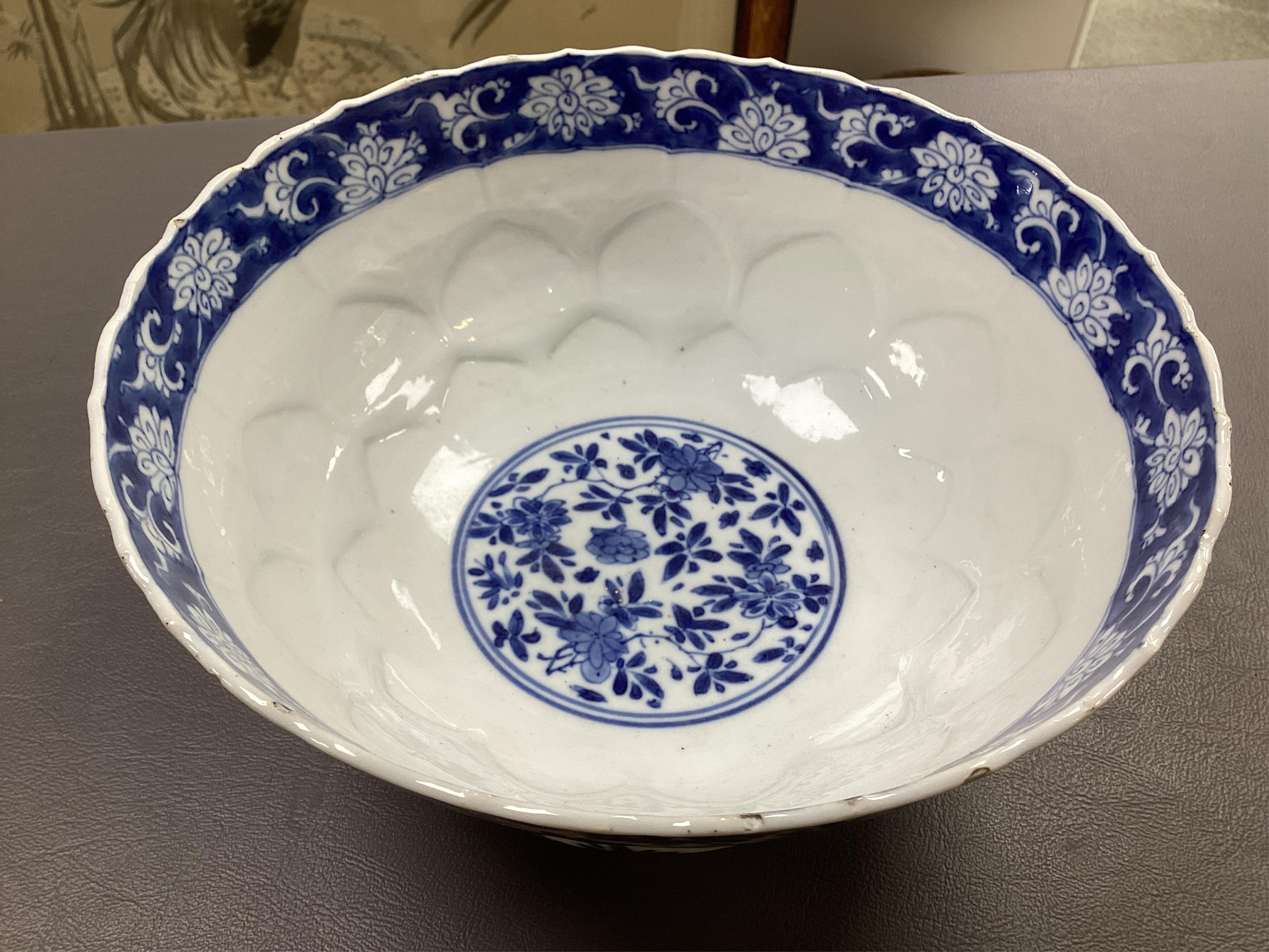 A near pair of Chinese blue and white lotus flower moulded bowls, Kangxi period